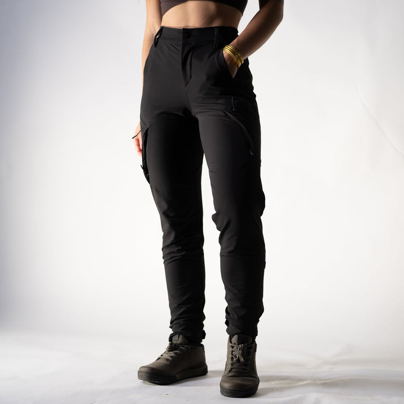 Person wearing black pants and boots on a plain background
