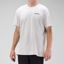 Person wearing a white t-shirt with a logo on a gray background